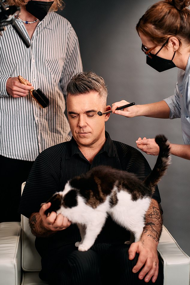 Adorable: The photos that broke the news showed Robbie holding a mug that read 