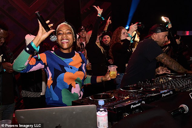 In the DJ booth: The actress was seen warming up the audience while standing next to the DJ.