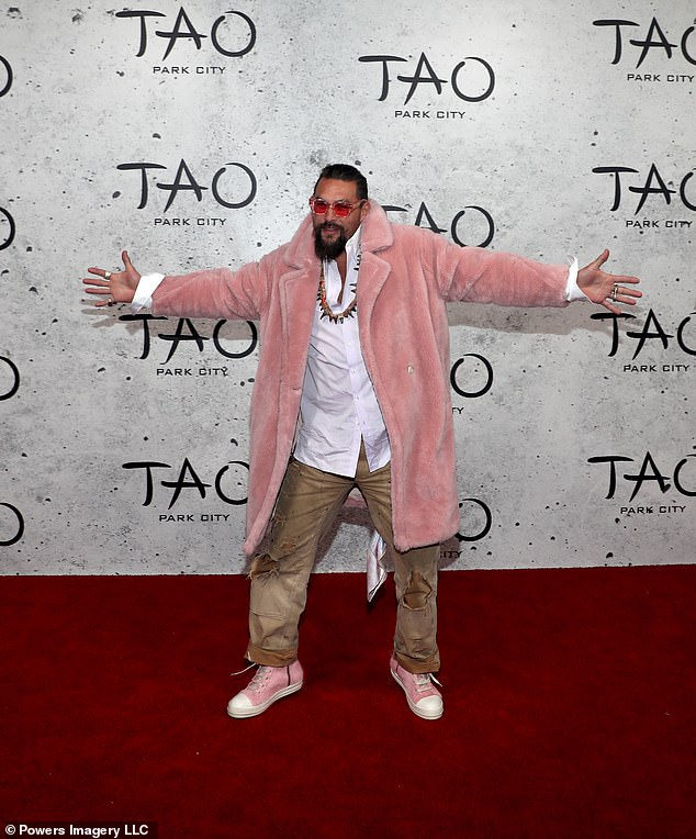 Think pink: Jason Momoa, 43, looked great as always, wearing a light pink fur coat over a white shirt and distressed brown jeans