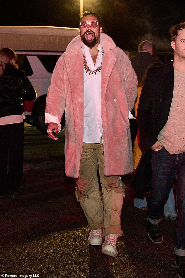 Cool boy: He coordinated his shoes with his jacket, rocking light pink sneakers.