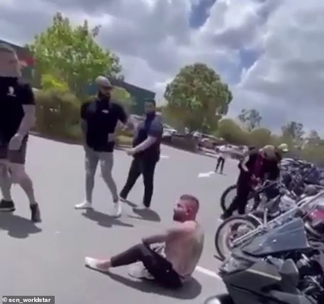 A dazed Tajjour, stripped of his shirt and red from the alleged assault, sits as the men pull out in the Nerang Bunnings car park on the Gold Coast.