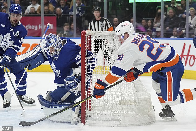 Nelson attempts a wrap around shot as Maples Leafs goalie Ilya Samsonov tries to cover the post.