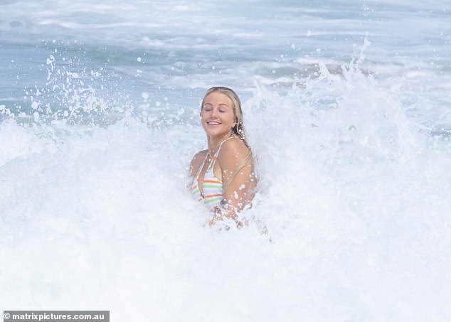 Ali could barely keep the smile from her face as she let the water wash over her and drench her golden hair.