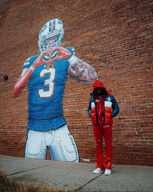 Damar Hamlin toyed with conspiracies, posing with a mural of him captioned: 'Clone'