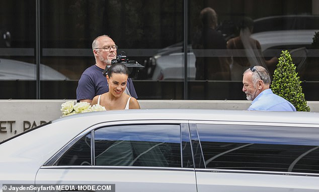 Bronte wore her dark hair in a slicked-back bun and completed her look with dangling earrings and an ivory bridal veil.