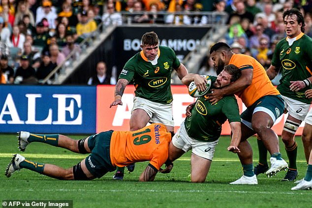 Taniela Tupou looks to stop Springbok Francois Steyn with an arm around his chest and neck area.  A tackle like this would be banned in amateur English rugby