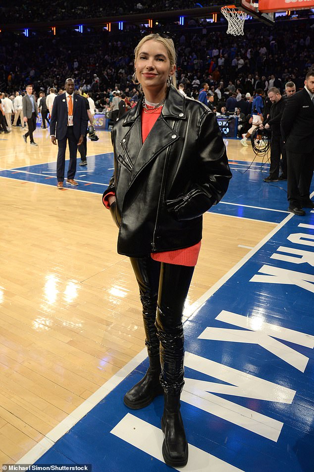 Chic on the court: Meanwhile, blonde beauty Ashley looked chic in a pair of leather-look pants, boots and a red top, which she teamed with a leather jacket