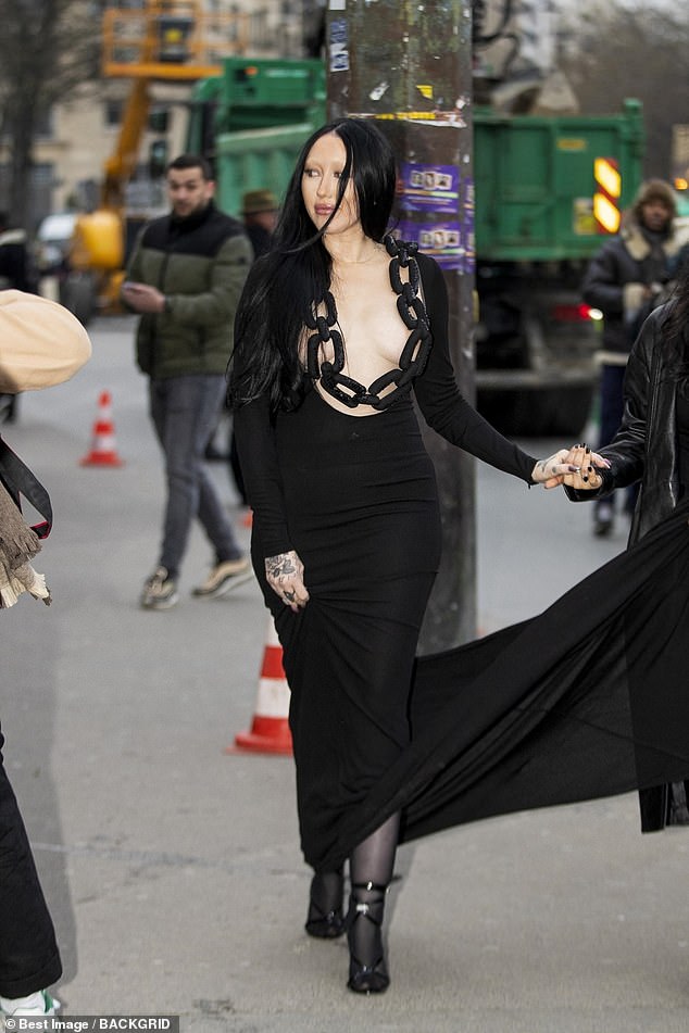 Wow!  The 23-year-old singer barely shielded her modesty as she went braless under the black dress that featured a thick chain detail that was strategically placed over her assets.