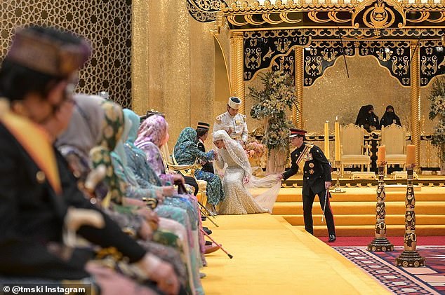 The bride bows to her stepmother during her official wedding ceremony in Brunei earlier this month.