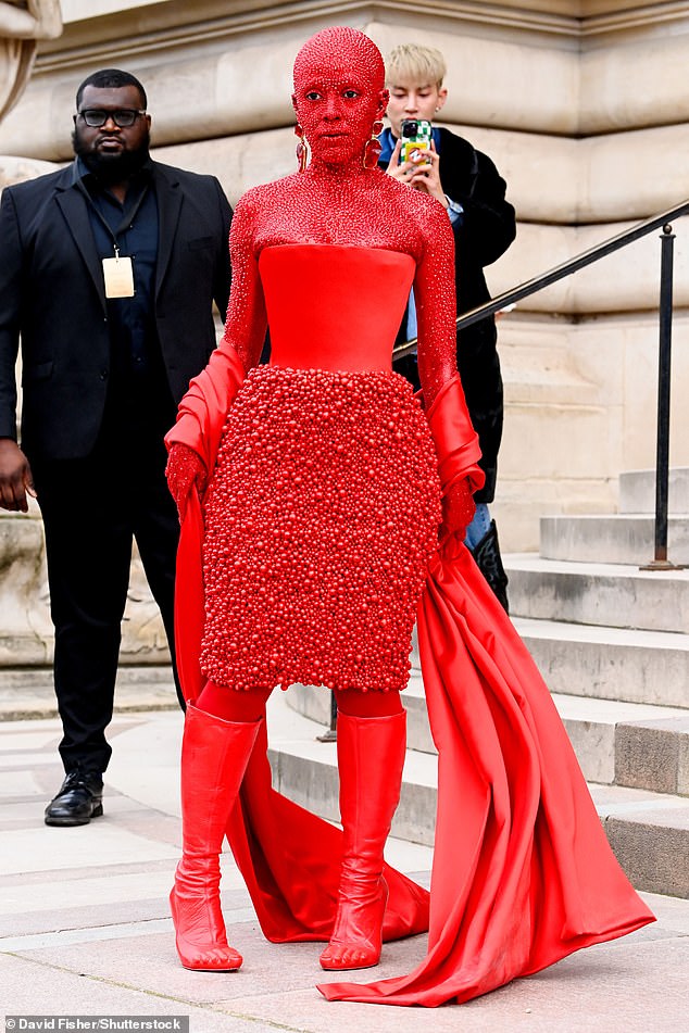 Lady in Red!  Doja Cat, 27, turned heads when she arrived at the star-studded Schiaparelli show on Monday wearing a red satin corset paired with a lavishly beaded skirt and knee-high boots.  She arrived in head-to-toe red body paint and completed her daring outfit with color-coordinated crystals.