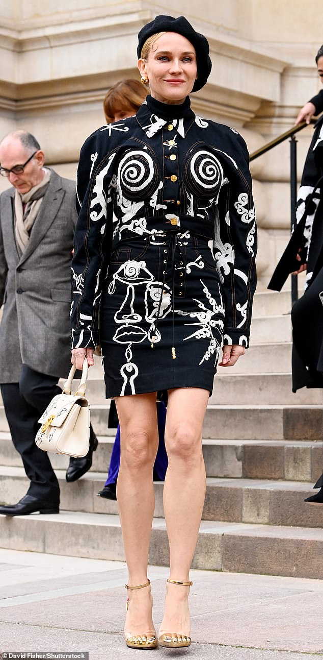 Stunning: Diane Kruger, 46, looked radiant in a quirky black and white mini dress as she arrived at the star-studded Schiaparelli show during Paris Fashion Week on Monday