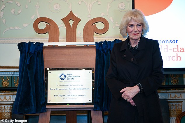 Camilla smiled as she stood next to the plaque she discovered during today's reception.