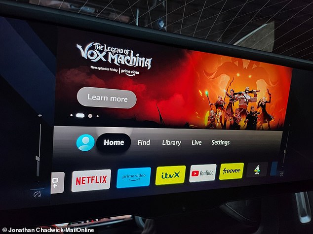 The 8K screen, measuring 32 inches by 9 inches, drops down from the moonroof at the touch of a button and streams videos from Netflix, YouTube and more