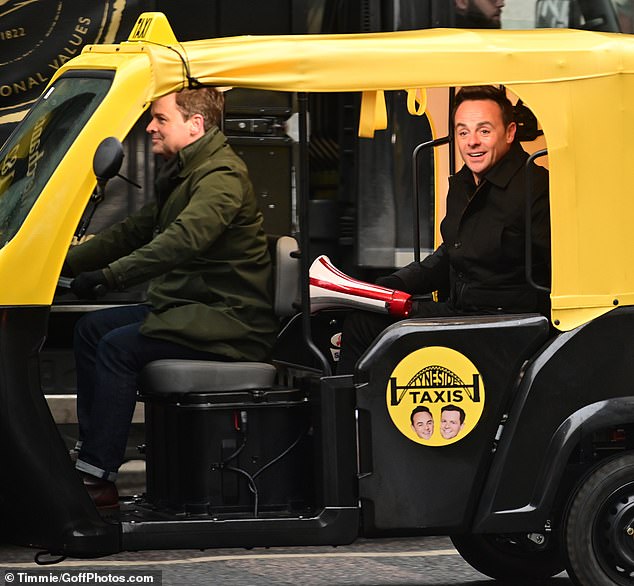 Arriving in style: The Geordie duo looked lively as they commanded attention in the yellow and black motorized rickshaw, nicknamed 'Tyneside Taxis'