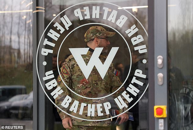 Pictured: A man wearing a camouflage uniform walks out of PMC Wagner Centre, which is a project implemented by the businessman and founder of the Wagner private military group Yevgeny Prigozhin, during the official opening of the office block in Saint Petersburg, Nov. 4