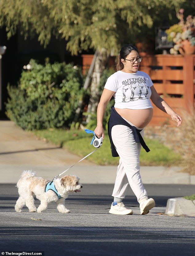 Fresh air: Rodriguez completed her causal ensemble with a pair of white sweatpants, sneakers, and a black sweatshirt wrapped around her waist