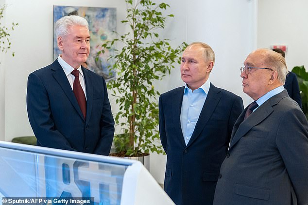 Russian President Vladimir Putin (C), accompanied by Moscow Mayor Sergei Sobyanin (L) and Moscow State University rector Viktor Sadovnichy, visits the Moscow State University on Student's Day in Moscow on January 25, 2023