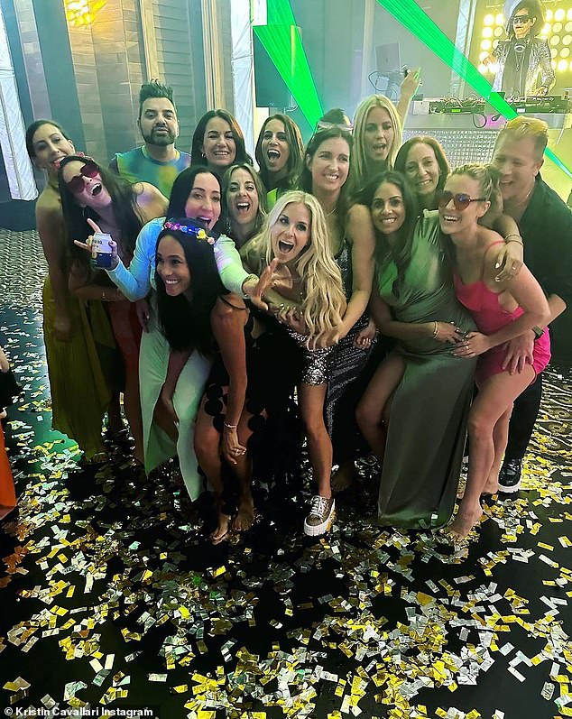 All together: At the party, everyone posed for a group photo surrounded by gold and silver confetti with the DJ behind them.