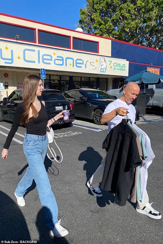 Laid back: Brett, who stars in the hit Netflix series Selling Sunset alongside his twin brother Jason, looked effortlessly cool in a white T-shirt and khaki pants