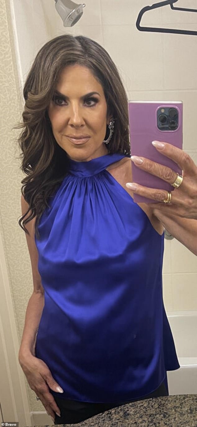 Stunning: Jennifer Fessler rocked a cobalt blue halter dress, two gold rings and her hair in bouncy curls