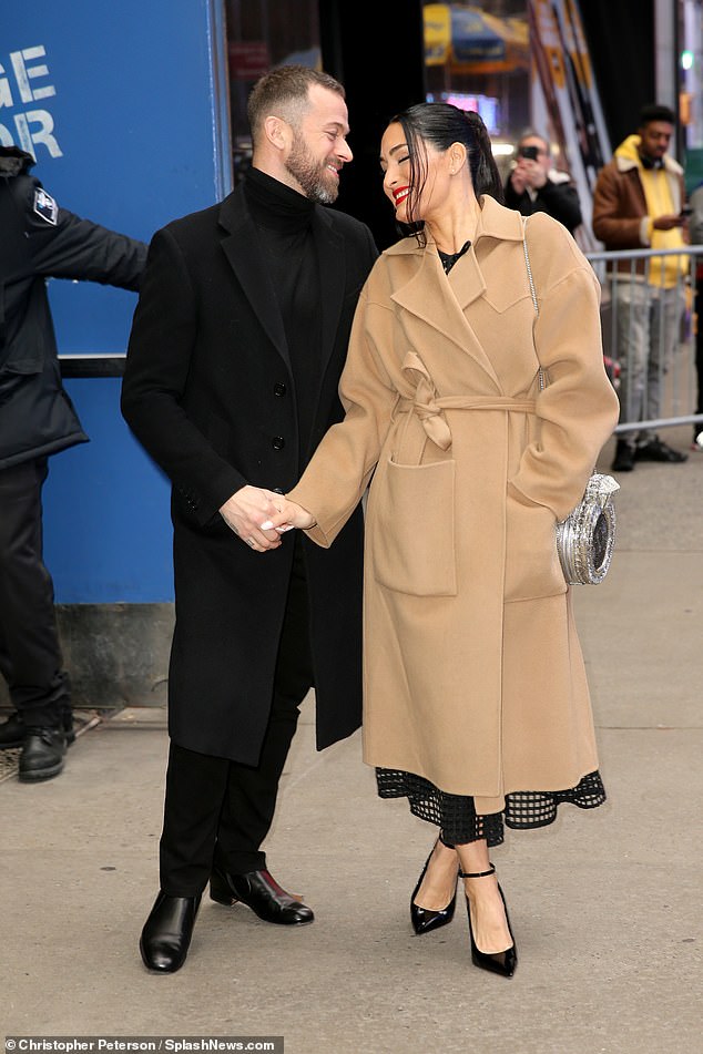 Chic: For her look, the reality star looked radiant in a black mesh midi dress, a silver engagement ring clutch and bright red lipstick