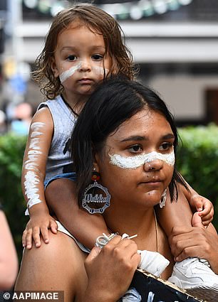 Invasion Day rally protests January 26 as Australia's national holiday (a protester in Brisbane pictured)