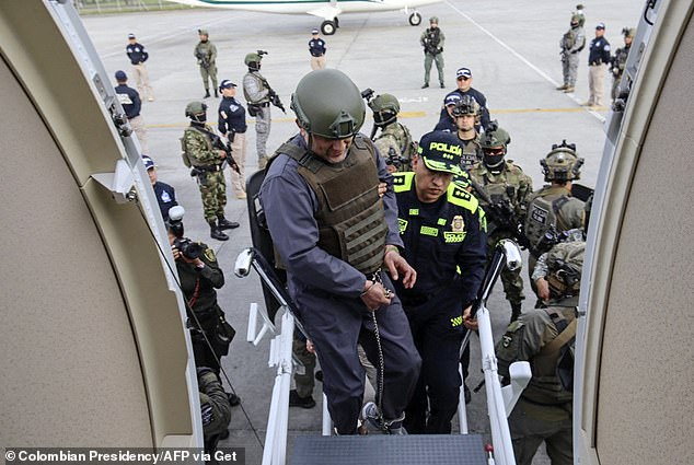 Colombian drug trafficker and head of the Clan del Golfo, Dairo Antonio Usuga, also known as 'Otoniel', boards a plane to be extradited to the US, in Bogota on May 4, 2022.