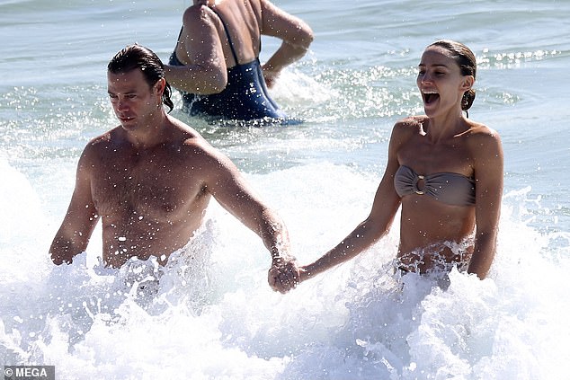 Rachael and Michael looked delighted as they splashed in the sea.