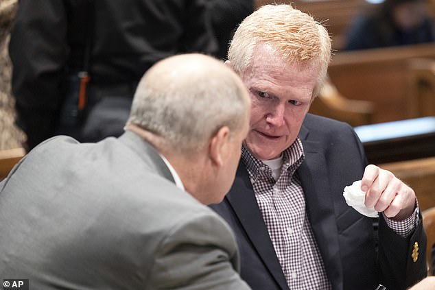 Murdaugh holds up a handkerchief as he talks to his attorney Jim Griffin