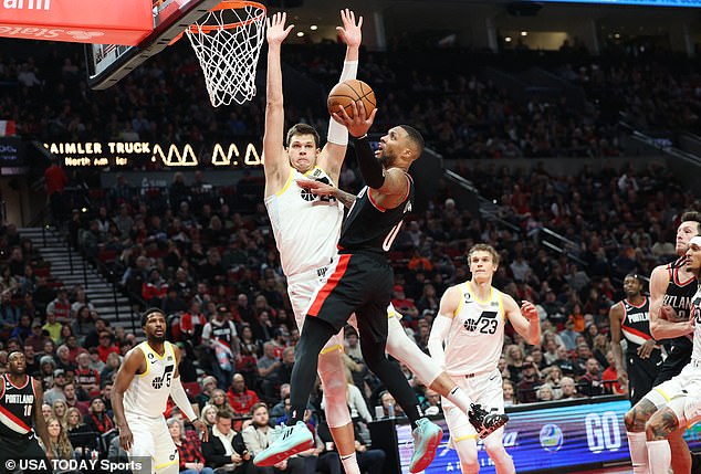 Lillard (0) shoots over Utah Jazz forward Jarred Vanderbilt (8) in the second half of basketball