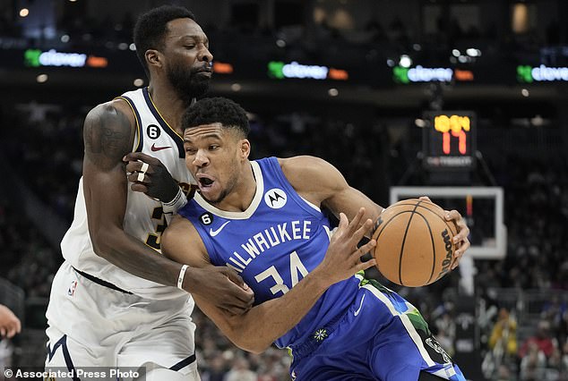 Giannis Antetokounmpo of the Milwaukee Bucks is fouled by Denver Nuggets forward Jeff Green