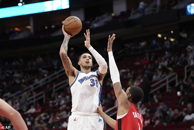 Kyle Kuzma (33) of the Washington Wizards shoots while Jabari Smith Jr. (1) of the Houston Rockets