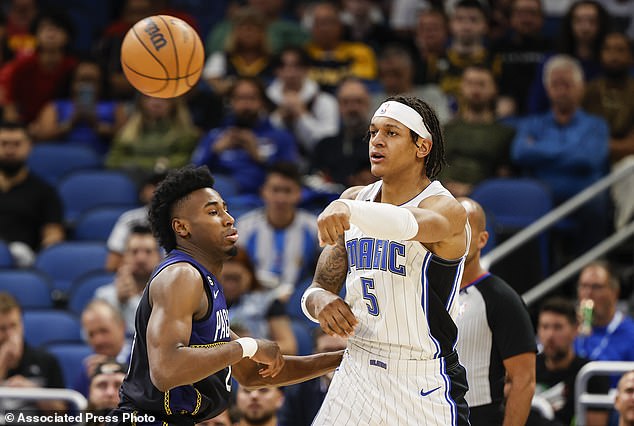 Magic forward Paolo Banchero passes the ball while being defended by Pacers Aaron Nesmith