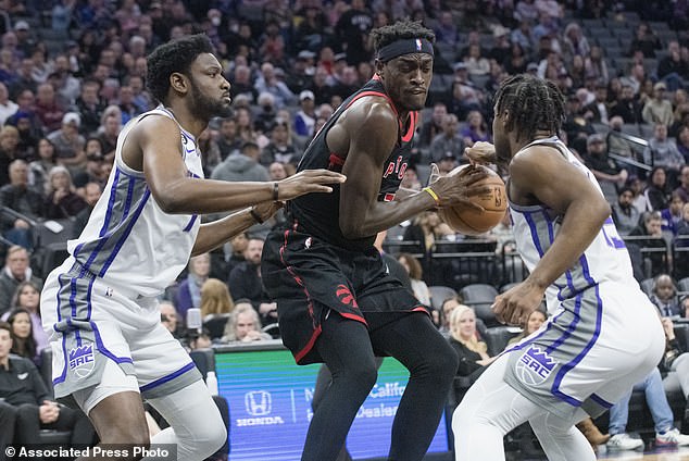 Sacramento Kings forward Chimezie Metu, left, and Sacramento Kings guard Davion Mitchell, Toronto Raptors guard Pascal Siakam during the first quarter