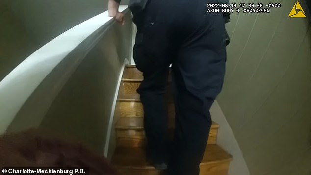 The officers start up the stairs showing them his room, which has a door locked inwards.  The three officers try to talk to Donahue without opening the door, and one asks, 'It's the police, ma'am.  You can open the door?