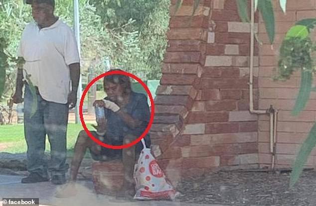 The prime minister said rural communities had moved to Alice Springs in the wake of inland flooding, which had heightened local tensions with drink and drug abuse (pictured, a local reportedly drinking a 'cocktail of hand sanitizer')