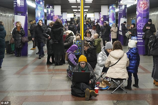 People gather in a subway station being used as a bomb shelter during a rocket attack in Kyiv today