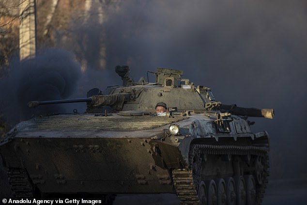 A Ukrainian soldier is seen on his way to frontlines with their armoured military vehicles as strikes continue