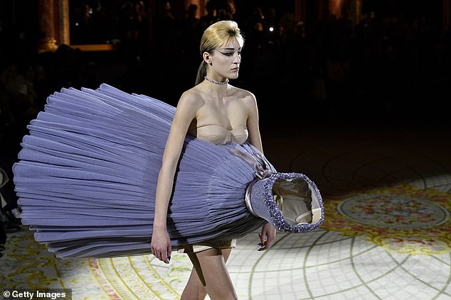 Unusual: Doja's interesting look somewhat mirrored Viktor and Rolf's unusual runway where the models wore the dresses.