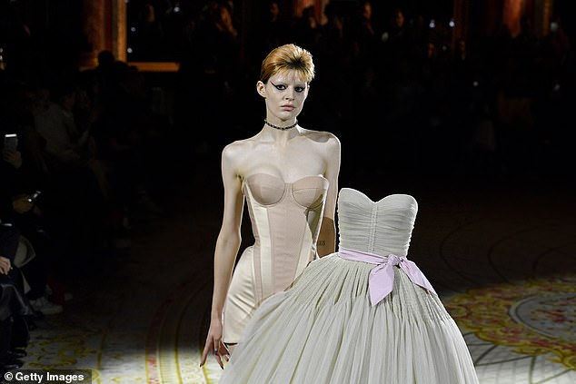 Different: Ball gowns paraded down the catwalk while the models wore corseted underwear