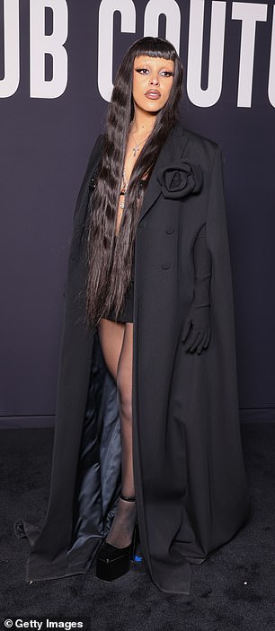 Change: Within hours, Doja arrived at Valentino wearing an all-black ensemble and a long, sleek wig.
