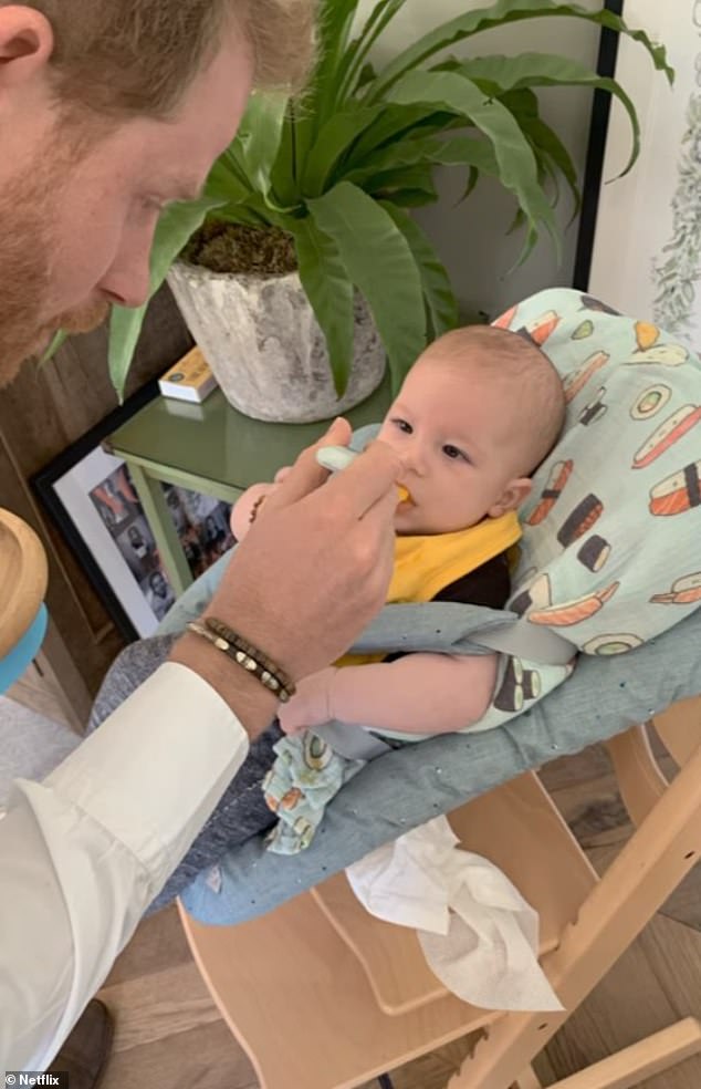 Prince Harry is seen feeding Archie in his sushi-themed high chair;  Lorren described the Sussexes as 'hands-on' parents