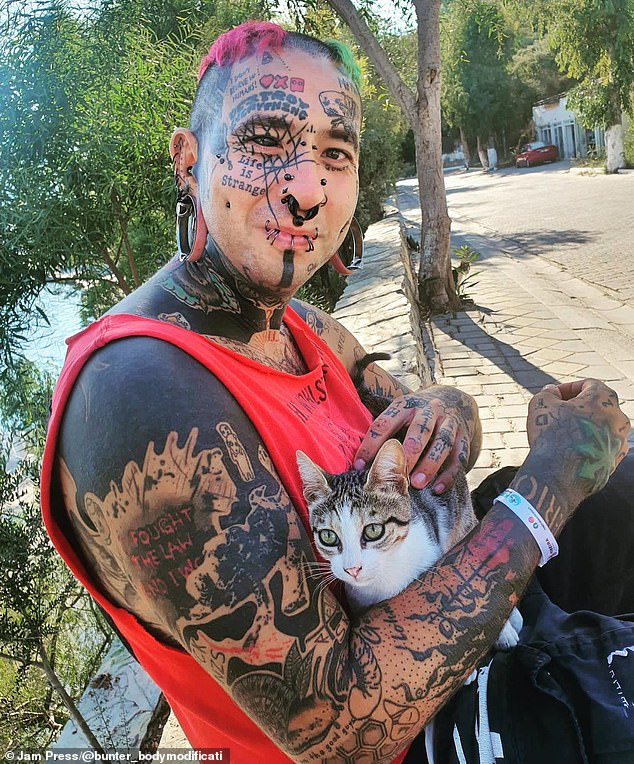 Tobias Müller, 33, (pictured) a zookeeper from Dortmund, Germany, regularly makes headlines with his controversial look, which has seen his entire body covered in more than 300 tattoos 