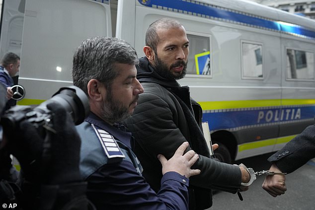 Andrew Tate is led in handcuffs to Bucharest's directorate for investigating organised crime and terrorism building on Thursday