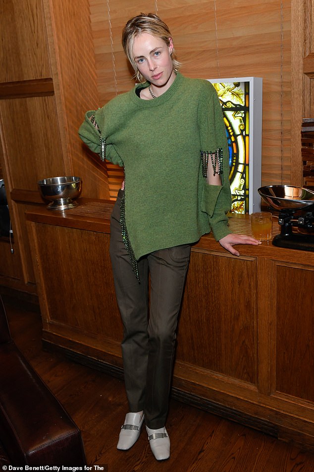 Chic: Model Edie looked chic in a green cropped jumper and beige pants in the evening