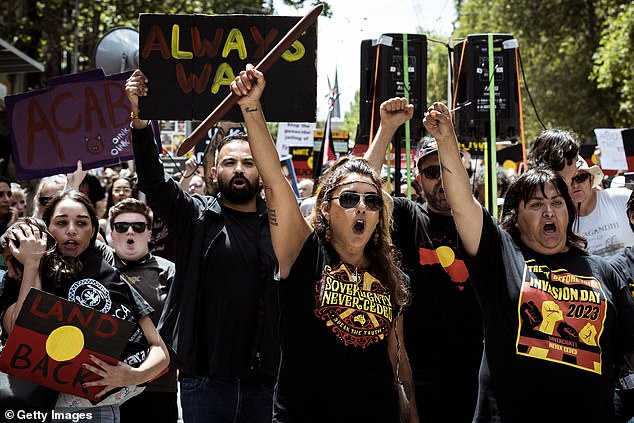 Green Senator Lidia Thorpe (centre, holding a 'battle stick') takes part in the Invasion Day rally on January 26, 2023 in Melbourne.