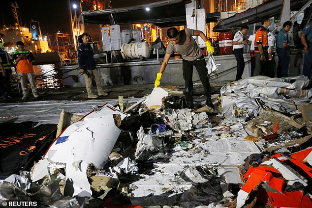 Investigators with the US National Transportation and Safety Board (NTSB) examine debris at the crash site of Ethiopian Airlines Flight ET 302 on March 12, 2019 in Bishoftu, Ethiopia.