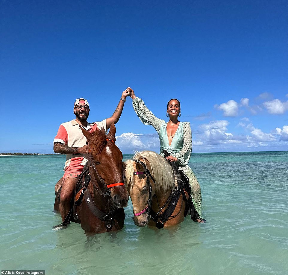 The love of her life: Here she is seen holding Swizz's hand as they pose side by side on their horses.