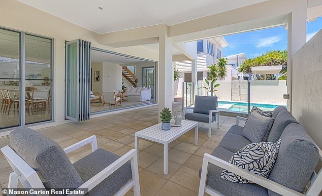 The ultra-chic, modern design captures a perfect vacation mood with floor-to-ceiling glass panels on both floors and a spacious open plan Pictured: One of several living areas