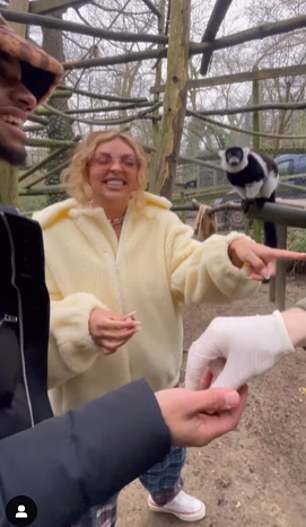 Love: Jesy smiled with Zion as they enjoyed feeding the animals.